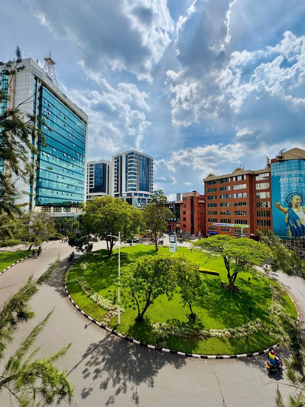 Sunny downtown Kigali with green gardens and modern buildings